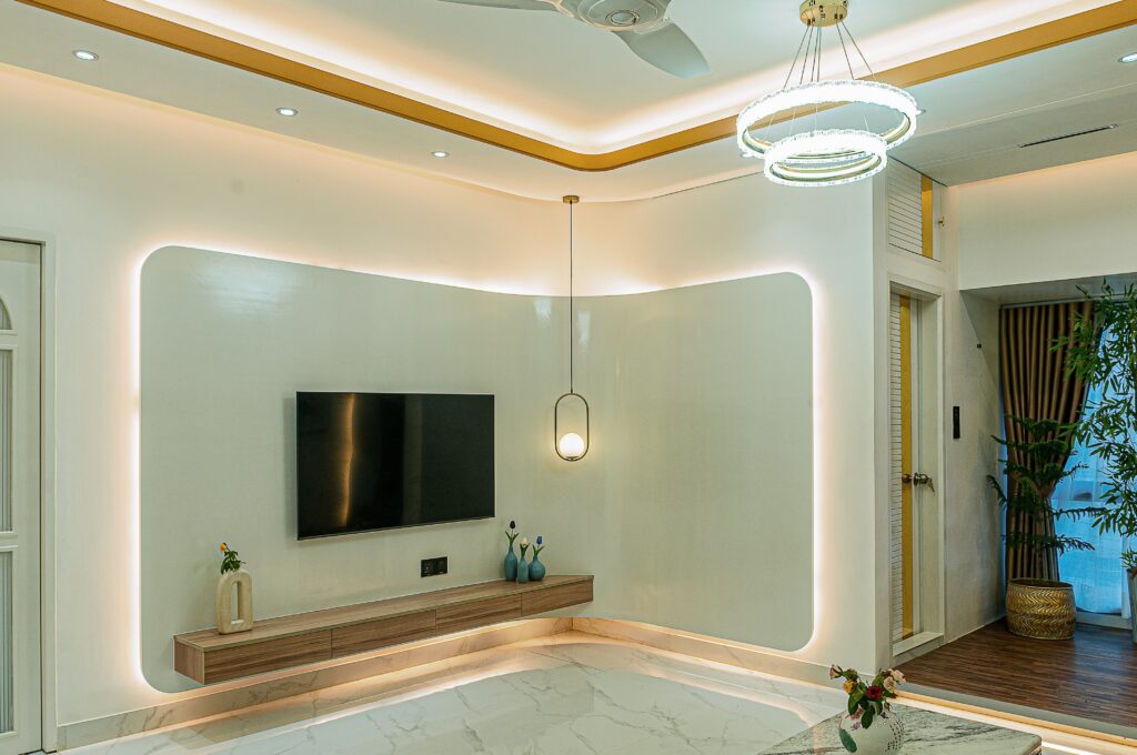 Modern living room with a large TV, soft seating, and a comfortable, relaxed feel.